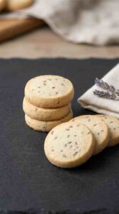 lavender-shortbread-cookies-hero-shot-1-stacked-and-fanned-cookies-on-slate