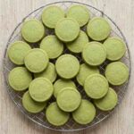 matcha-shortbread-cookies-hero-shot-1-stacked-cookies-with-green-tea-on-slate
