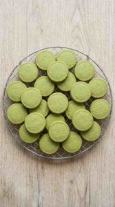 matcha-shortbread-cookies-hero-shot-1-stacked-cookies-with-green-tea-on-slate